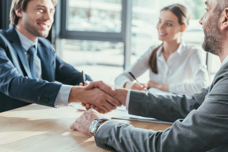 Business Insurance - Business People Shaking Hands During a Meeting in a Modern Office